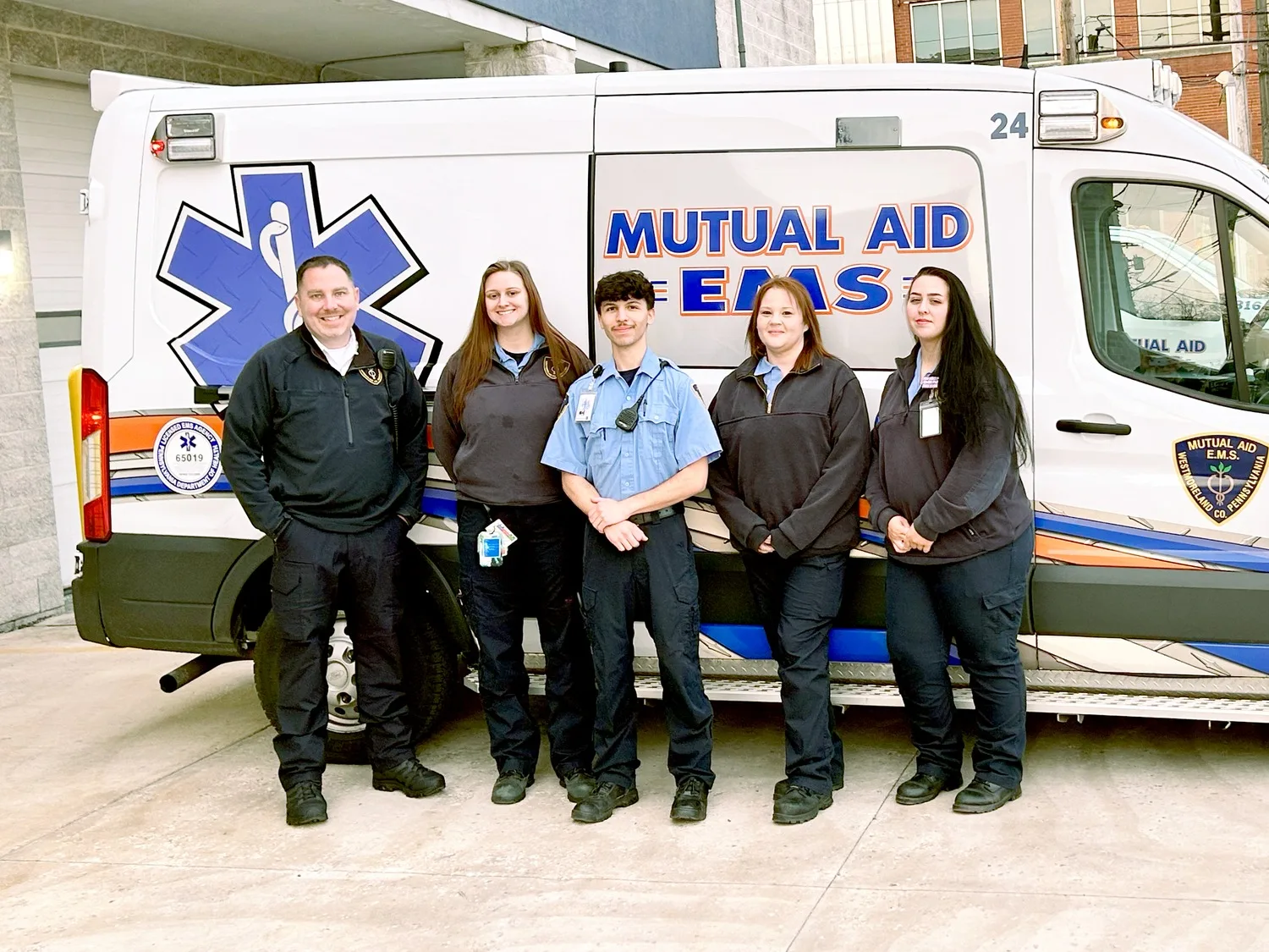 A Mutual Aid EMS crew in front of one of their ambulances